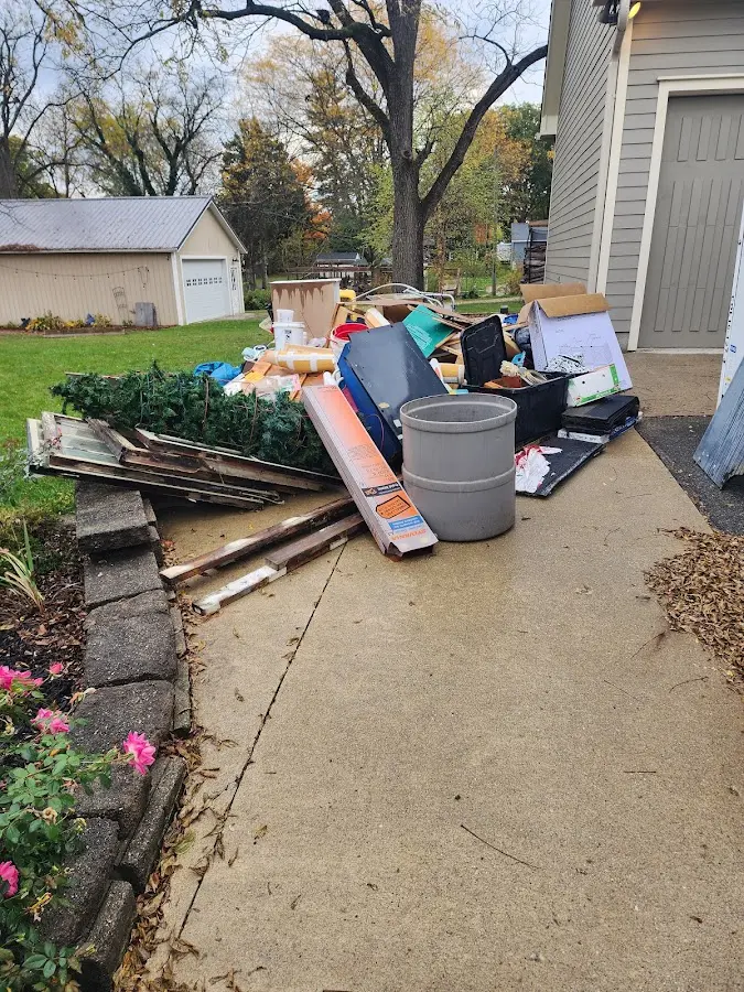 Dumpster being loaded with debris for Roofing Dumpster Rental in Chatham